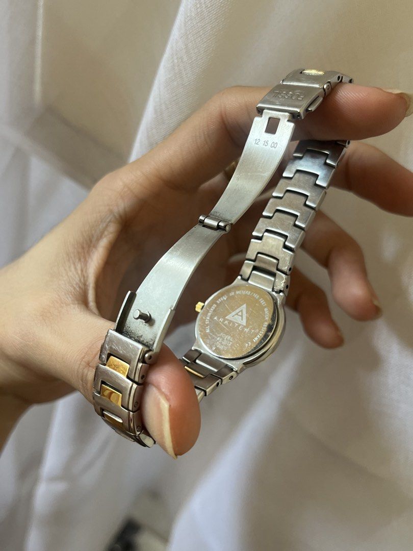 Fossil Arkitekt Watch (Category: Women's Watches) located in Pasig City. Submitted by makexup (Listing ID 1423644494, Image 2). Description: - Fossil Arkitekt watch - Two-tone design - Black dial with gold-tone hands - Diamond accent - Stainless steel band with gold-tone accents - Deployment clasp - Marked "Arkitekt" and "12 15 00" on the back.
