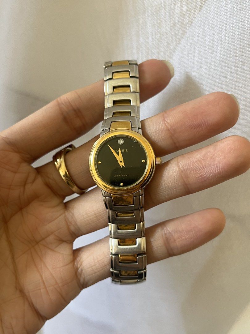 Fossil Arkitekt Watch (Category: Women's Watches) located in Pasig City. Submitted by makexup (Listing ID 1423644494, Image 1). Description: - Fossil Arkitekt watch - Two-tone design - Black dial with gold-tone hands - Diamond accent - Stainless steel band with gold-tone accents - Deployment clasp - Marked "Arkitekt" and "12 15 00" on the back.