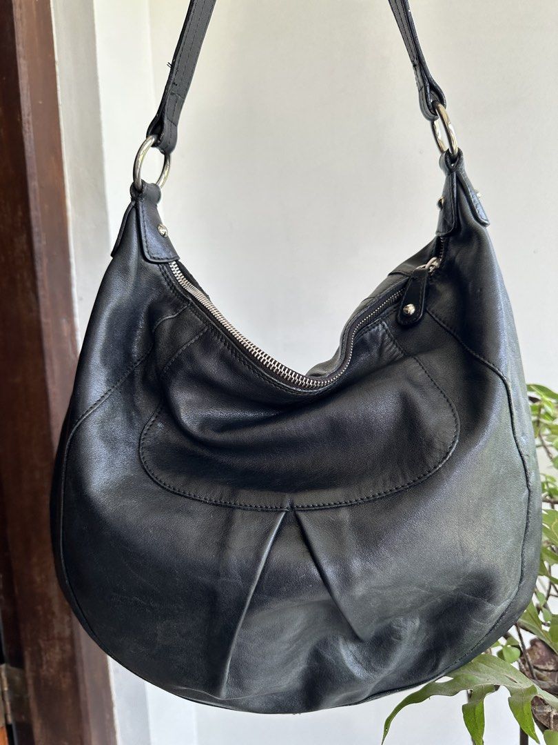 Furla Black Leather Hobo Bag (Category: Luxury Bags & Wallets) located in Bombon. Submitted by cookiespreloveed (Listing ID 1423751256, Image 3). Description: - Furla black leather hobo bag - Silver-tone metal tag and hardware - Secure zipper closure - Spacious interior with Furla logo lining - Comfortable shoulder strap - Durable YKK zipper.