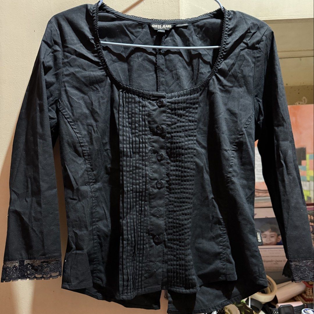 Guess Jeans Black Blouse - Size L (Category: Blouses) located in Manila. Submitted by md2897 (Listing ID 1423759926, Image 1). Description: - Guess Jeans black blouse - Size L - Scoop neckline - Long sleeves with lace cuffs - Button-down front with pleated detailing - Lace tie back detail - Made of stretch material.