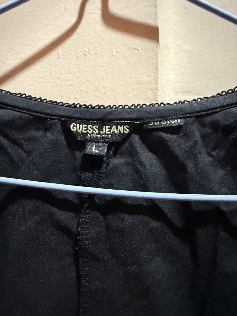 Guess Jeans Black Blouse - Size L (Category: Blouses) located in Manila. Submitted by md2897 (Listing ID 1423759926, Image 2). Description: - Guess Jeans black blouse - Size L - Scoop neckline - Long sleeves with lace cuffs - Button-down front with pleated detailing - Lace tie back detail - Made of stretch material.