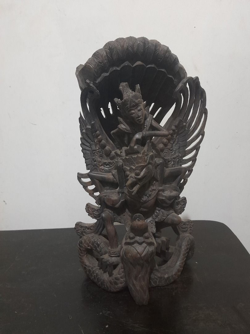 Hand-Carved Wooden Garuda Statue (Category: Other Home Decor) located in Tuguegarao City. Submitted by nobleflower_bb6691 (Listing ID 1423711329, Image 1). Description: - Hand-carved wooden Garuda statue - Depicts a mythical bird-like creature - Features detailed wings and serpent base - Includes figures within the design - Dark, natural wood finish - Perfect for display or collection.