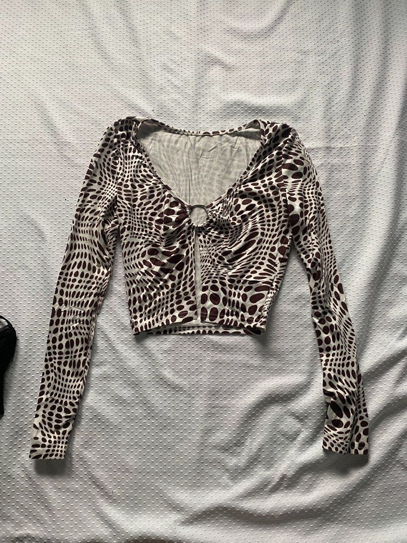 Long Sleeve Crop Top with Ring Detail (Category: Blouses) located in Santa Rita. Submitted by jayiwishes (Listing ID 1423660703, Image 1). Description: Brown & white patterned crop top with V-neck and ring detail. Fitted silhouette, long sleeves. Pair with high-waisted bottoms..