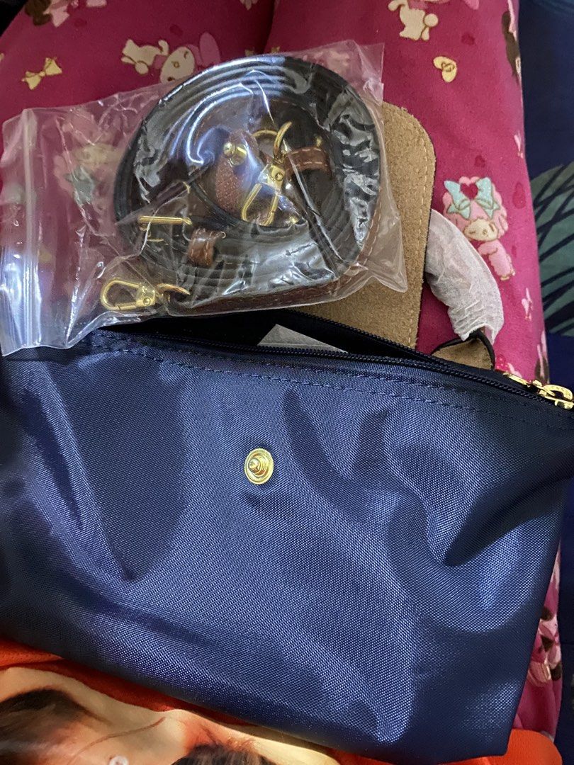 Longchamp Le Pliage Cuir Crossbody Bag (Category: Luxury Bags & Wallets) located in Zamboanga. Submitted by smartstyle (Listing ID 1423464708, Image 2). Description: - Authentic Longchamp Le Pliage Cuir crossbody bag - Color: Navy blue body with brown leather flap and handles - Detachable shoulder strap - Top handle - Gold-toned hardware - Snap closure with Longchamp logo.