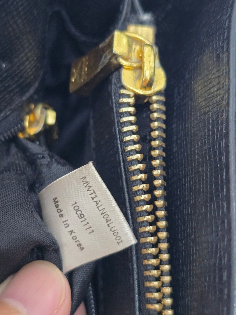 MCM Black Tote Bag (Category: Luxury Bags & Wallets) located in Las Pinas. Submitted by vanpru (Listing ID 1423778655, Image 3). Description: MCM mini tote bag Made in korea With signs of usage and creases but still good 2k - Authentic MCM tote bag - Color: Black - Hardware: Gold-tone - Closure: Top zipper - Interior pocket - Handles: Two - Shape: Rectangular - MCM logo visible - Made in Korea.