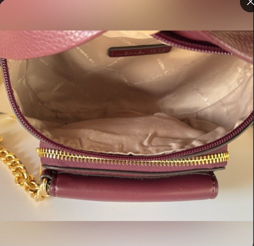 Michael Kors Leather Fanny Pack (Category: Luxury Bags & Wallets) located in Baguio. Submitted by msgold2601 (Listing ID 1423663859, Image 3). Description: - Michael Kors fanny pack - Rich burgundy leather exterior - Includes a matching small wallet - Gold chain detail - Adjustable beige strap - Multiple compartments: zippered main, front pocket - Light-colored fabric lining.
