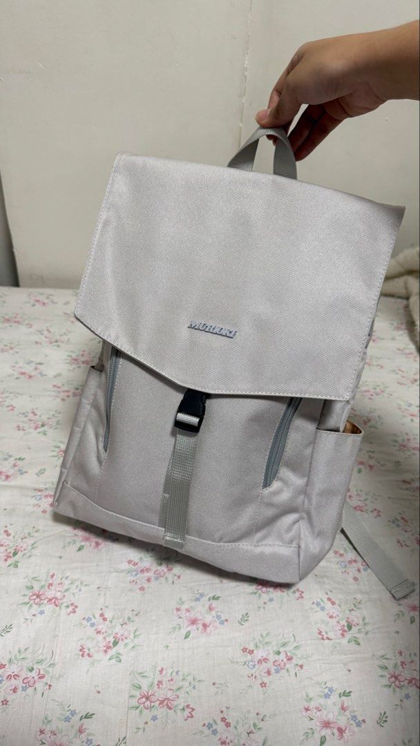Murioki Grey Backpack (Category: Backpacks) located in Valenzuela. Submitted by .manel. (Listing ID 1423757922, Image 1). Description: Brand New just unboxed it to promote in black app. Selling it a little bit lower. AGAIN THIS IS BRAND NEW and auto pass and no to hagglers. Grey backpack features a flap closure with a buckle and a top handle. It has two side pockets and adjustable shoulder straps. The interior has multiple compartments and a zipp