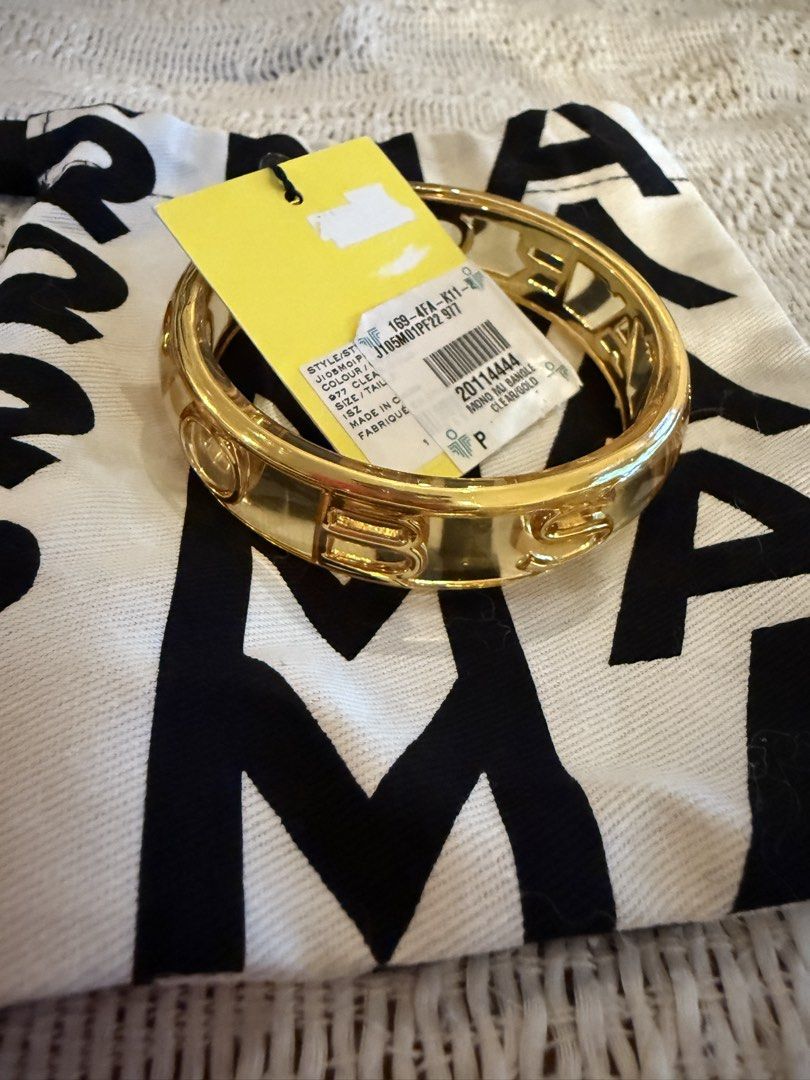 Marc J*cobs Gold Bangle (Category: Bracelets) located in Paranaque City. Submitted by izdeclutters (Listing ID 1423721351, Image 1). Description: Gold-colored bangle from MJ with original tag and bag. Authentic RFS: decluttering.