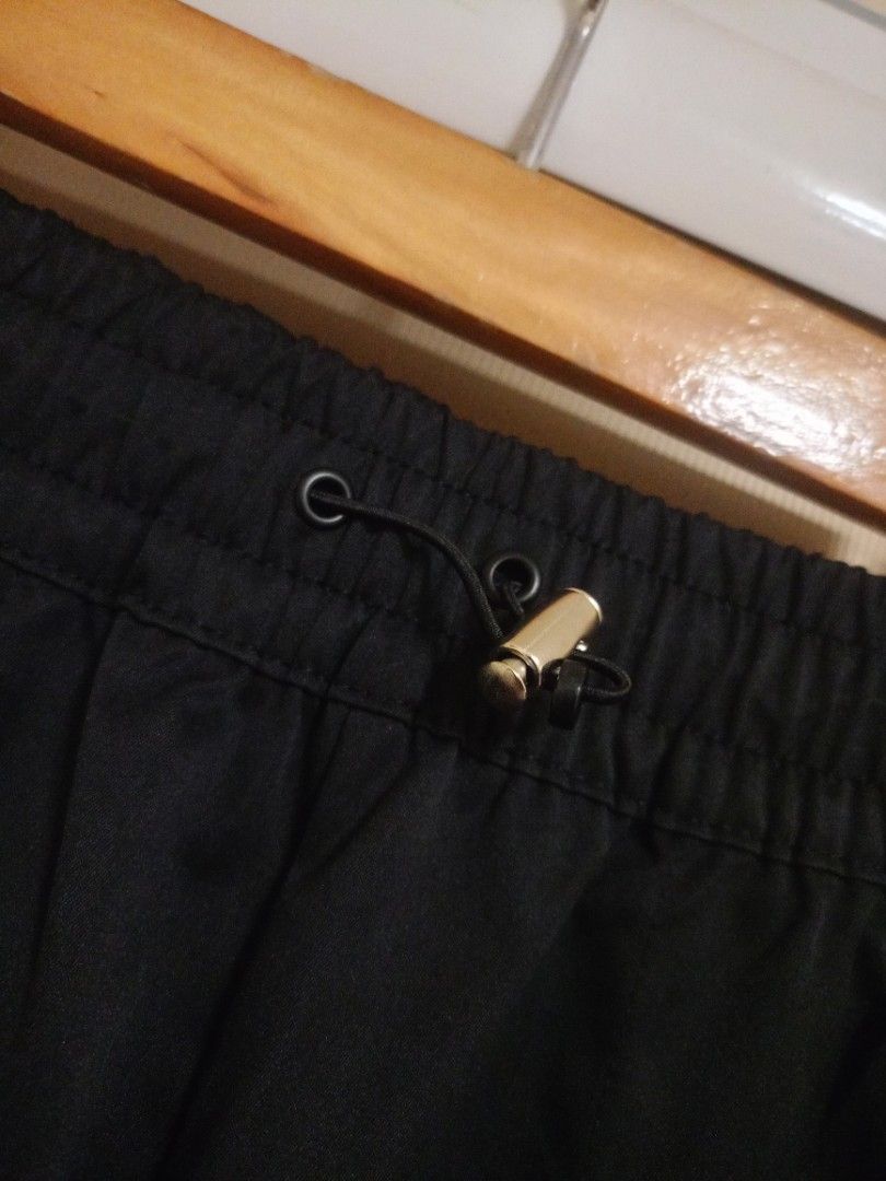 Nike Swoosh Woven Pants - Size S (Category: Joggers) located in Valenzuela. Submitted by One.Only.Nan (Listing ID 1423746994, Image 2). Description: Black Nike pants with an elastic waistband and drawstring. Features the Nike logo on the front. Includes pockets and elastic cuffs at the ankles. Made in China. Size S. Fits 28-30usm Length 38" MOP: GCASH MAYA AUB BPI VALENZUELA CITY LOC .