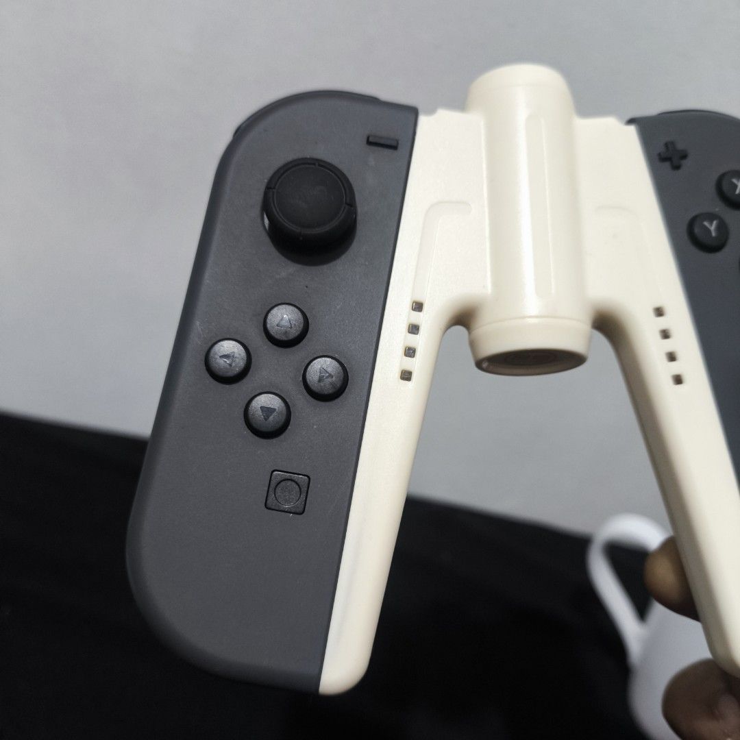 Nintendo Switch Joy-Con Controller (Category: Controllers) located in Valenzuela. Submitted by gearpandaph (Listing ID 1423656014, Image 3). Description: - Nintendo Switch Joy-Con controllers - Color: Gray - Includes grip attachment charging grip specifically - Standard buttons and joysticks - Good working condition.