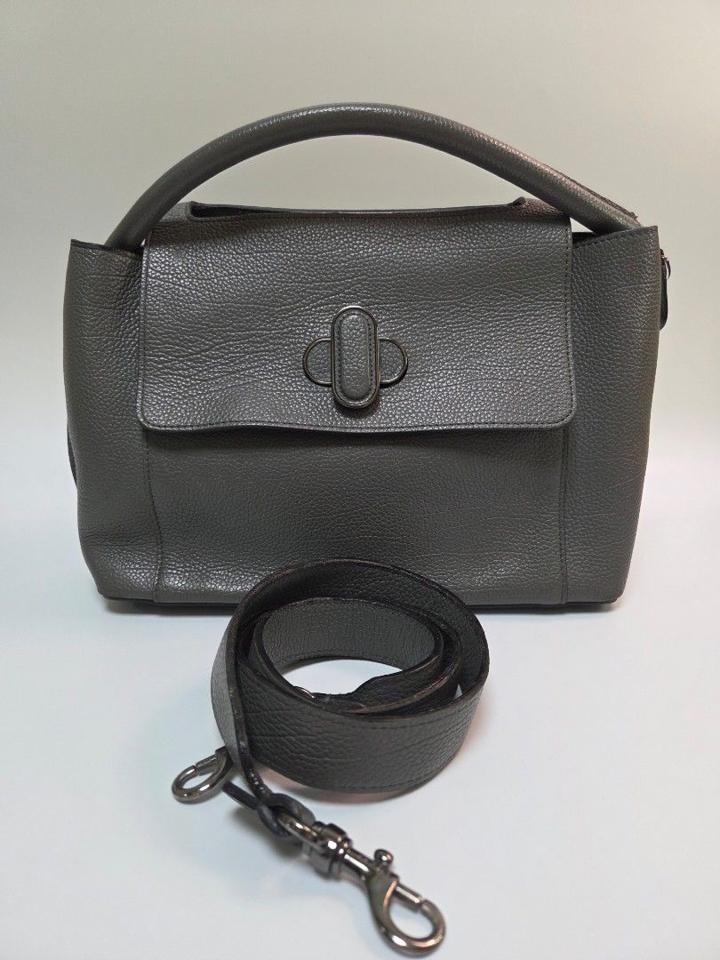 Original Dilak's Style Leather Bag (Category: Luxury Bags & Wallets) located in Quezon City. Submitted by robyns.closet.ph (Listing ID 1423768767, Image 1). Description: - Genuine leather bag - Flap closure with unique clasp - Detachable shoulder/crossbody strap - Top handle for easy carrying - Convenient front pocket - Textured leather finish - Versatile neutral color.