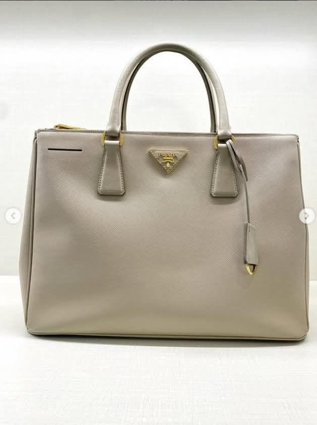 PRADA MEDIUM SAFFIANO DOUBLE ZIP TOTE BAG (Category: Luxury Bags & Wallets) located in Quezon City. Submitted by barbosac (Listing ID 1423762573, Image 2). Description: PRADA MEDIUM SAFFIANO DOUBLE ZIP TOTE BAG GRAY BEIGE STRAP, CLOCHETTE 53,500php.