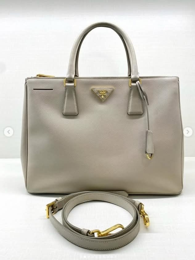 PRADA MEDIUM SAFFIANO DOUBLE ZIP TOTE BAG (Category: Luxury Bags & Wallets) located in Quezon City. Submitted by barbosac (Listing ID 1423762573, Image 1). Description: PRADA MEDIUM SAFFIANO DOUBLE ZIP TOTE BAG GRAY BEIGE STRAP, CLOCHETTE 53,500php.