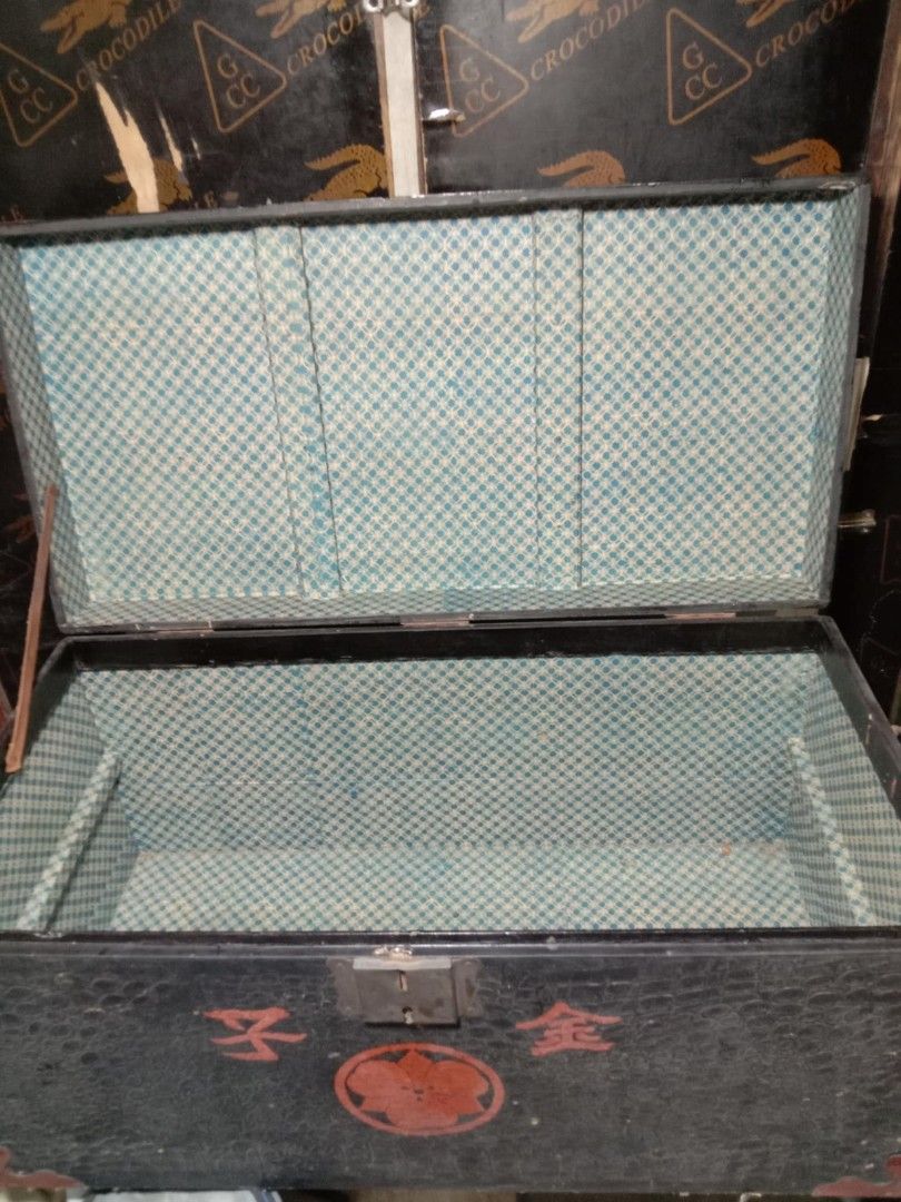 Vintage Black Storage Trunk (Category: Storage Boxes & Baskets) located in Quezon City. Submitted by jpnvintageonline (Listing ID 1423630590, Image 2). Description: - Vintage storage trunk - Black exterior with red corner accents - Patterned design - Latch closure - Blue and white checkered interior - Features Japanese characters and floral emblem -can re purpose as center table -issue cosmetic .