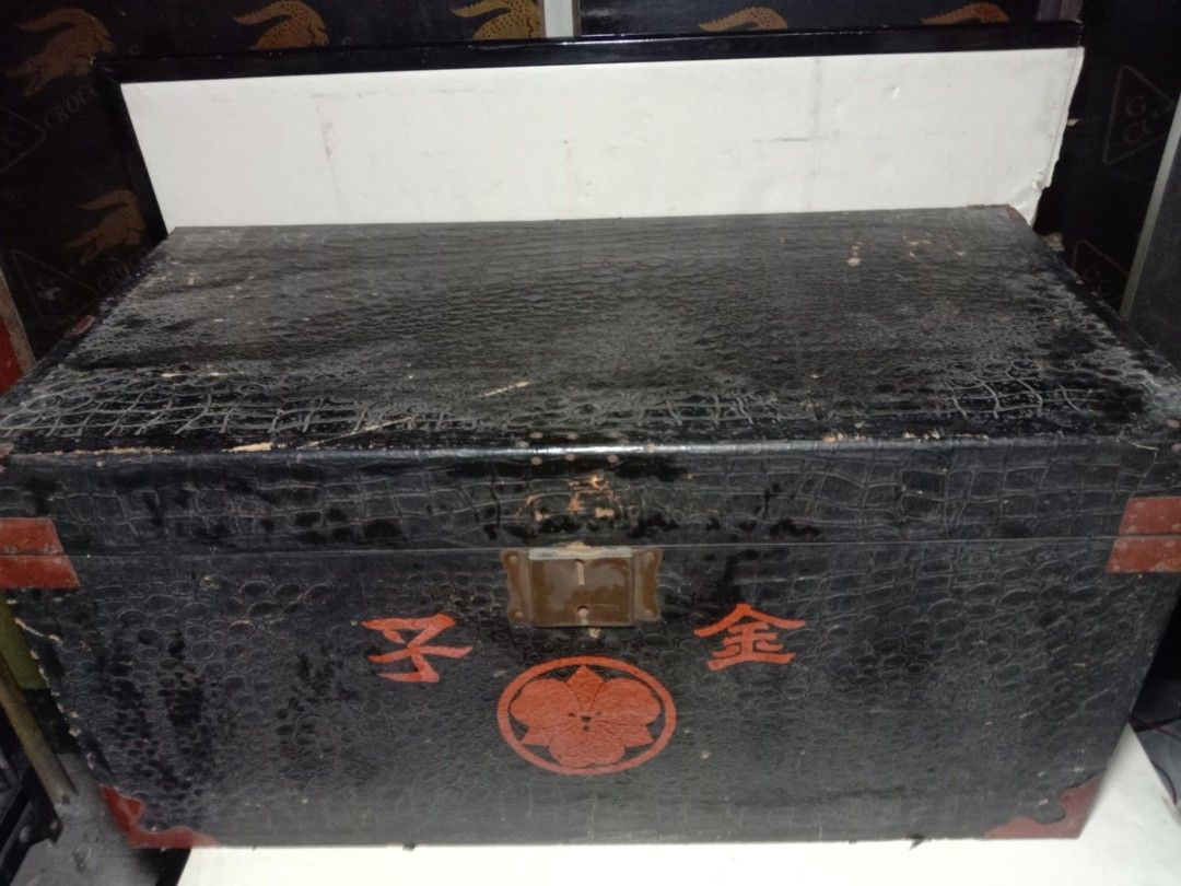Vintage Black Storage Trunk (Category: Storage Boxes & Baskets) located in Quezon City. Submitted by jpnvintageonline (Listing ID 1423630590, Image 1). Description: - Vintage storage trunk - Black exterior with red corner accents - Patterned design - Latch closure - Blue and white checkered interior - Features Japanese characters and floral emblem -can re purpose as center table -issue cosmetic .