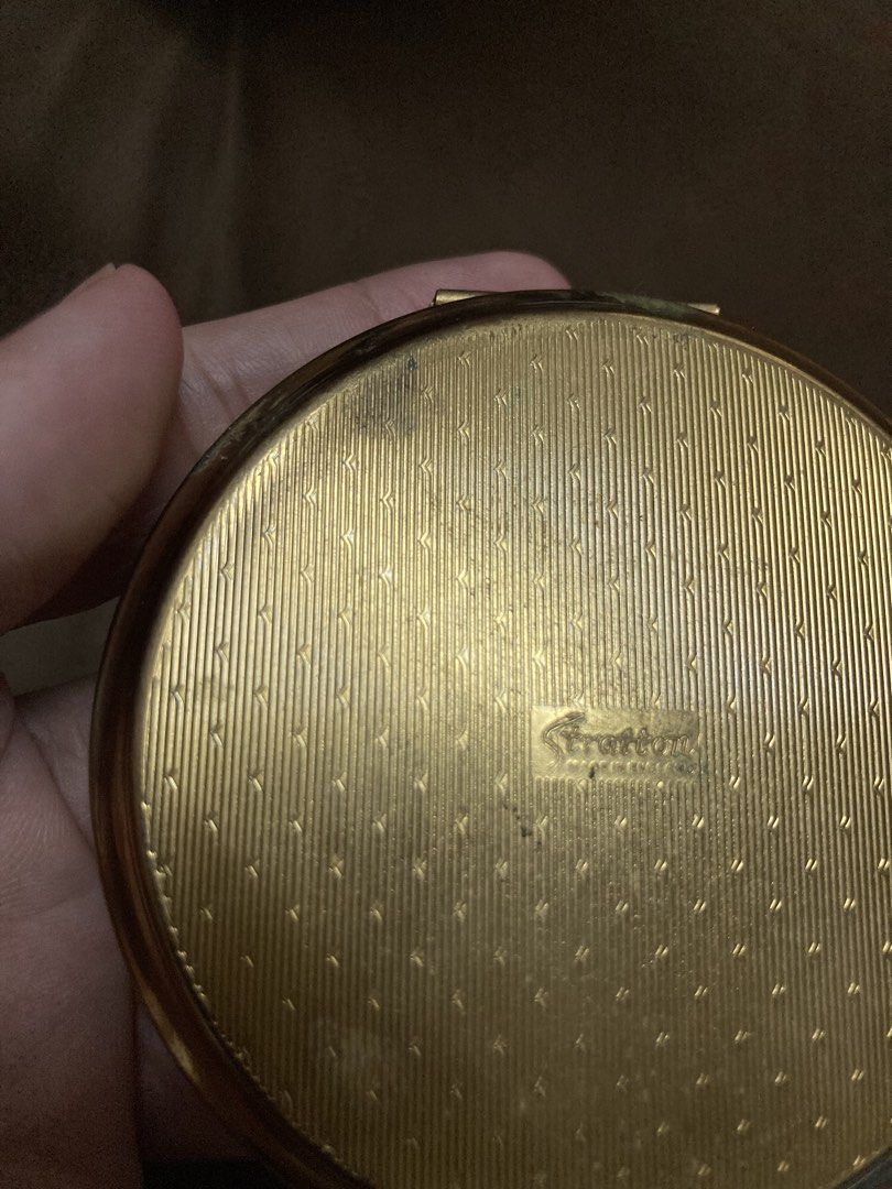 Vintage Stratton Powder Compact (Category: Makeup) located in Plaridel. Submitted by emilia.lily (Listing ID 1423695234, Image 3). Description: Beautiful vintage Stratton powder compact. Features an intricate floral design on the lid. The compact has a mirror and a powder screen. The back of the compact has a textured design. Includes the original powder puff. A lovely collectible item..