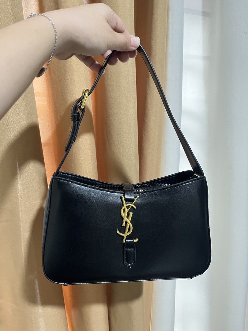 Y$L Hobo Bag Black Leather (Category: Luxury Bags & Wallets) located in Manila. Submitted by mistica.mnl (Listing ID 1423676553, Image 3). Description: - YSL hobo bag - Black leather with gold-tone hardware - Top handle design - Flap closure with YSL logo - Interior zippered pocket - Clean interior and exterior.