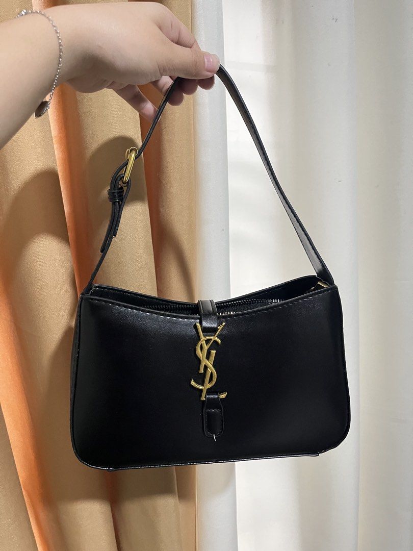 Y$L Hobo Bag Black Leather (Category: Luxury Bags & Wallets) located in Manila. Submitted by mistica.mnl (Listing ID 1423676553, Image 2). Description: - YSL hobo bag - Black leather with gold-tone hardware - Top handle design - Flap closure with YSL logo - Interior zippered pocket - Clean interior and exterior.