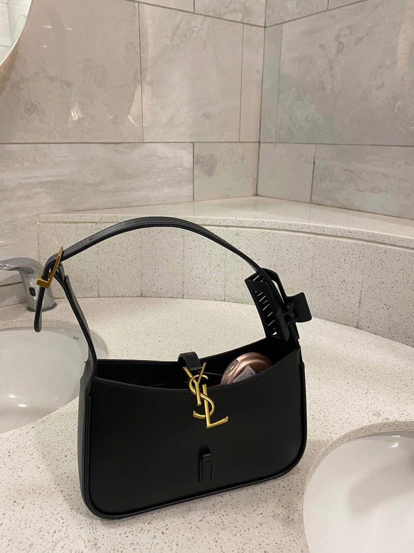 Y$L Hobo Bag Black Leather (Category: Luxury Bags & Wallets) located in Manila. Submitted by mistica.mnl (Listing ID 1423676553, Image 1). Description: - YSL hobo bag - Black leather with gold-tone hardware - Top handle design - Flap closure with YSL logo - Interior zippered pocket - Clean interior and exterior.