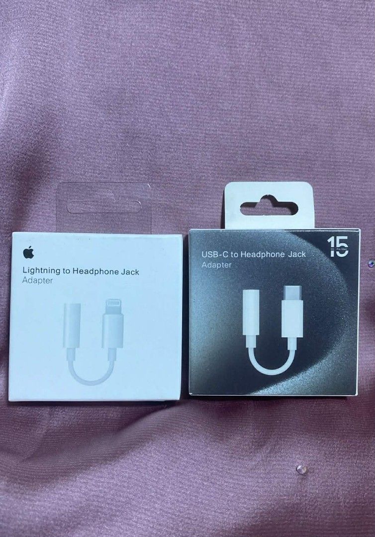 Apple Lightning to Headphone Jack Adapter & USB-C Adapter (Category: Chargers & Cables) located in Manila. Submitted by pricious (Listing ID 1423798437, Image 1). Description: Two Apple adapters are available: a Lightning to Headphone Jack Adapter and a USB-C to Headphone Jack Adapter. Both are in their original packaging. The USB-C adapter box has a "15" printed on it. These adapters allow you to connect your headphones to your Apple devices..