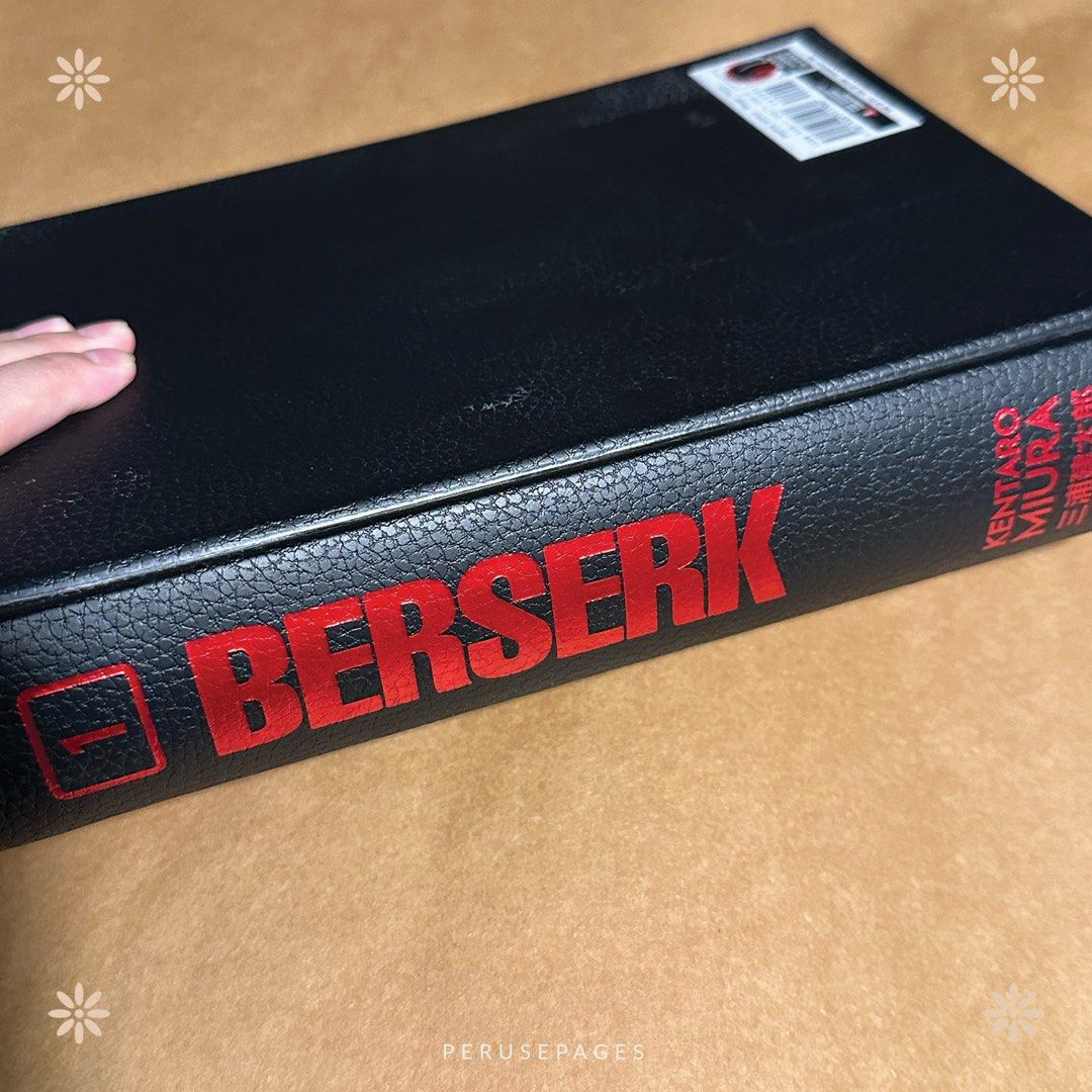 Berserk Deluxe Edition Volume 1 (Category: Comics & Manga) located in Pasig City. Submitted by seokchinicart (Listing ID 1423793396, Image 3). Description: - Berserk Deluxe Edition Volume 1 - By Kentaro Miura - Features the iconic Berserk logo and artwork - Includes parental advisory sticker - Preloved condition - Includes barcode and publisher information.