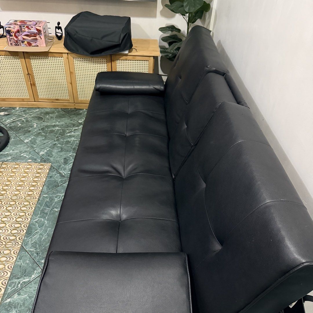 Black Futon Sofa Bed with Cup Holders (Category: Sofas) located in Manila. Submitted by preloveditemph (Listing ID 1423961212, Image 2). Description: - Black futon sofa bed - Sleek design with tufted cushions - Fold-down armrest with two cup holders - Converts easily into a bed - Sturdy wooden legs - Includes a storage compartment - Ideal for small spaces - Offers both seating and sleeping options Heavy Duty.