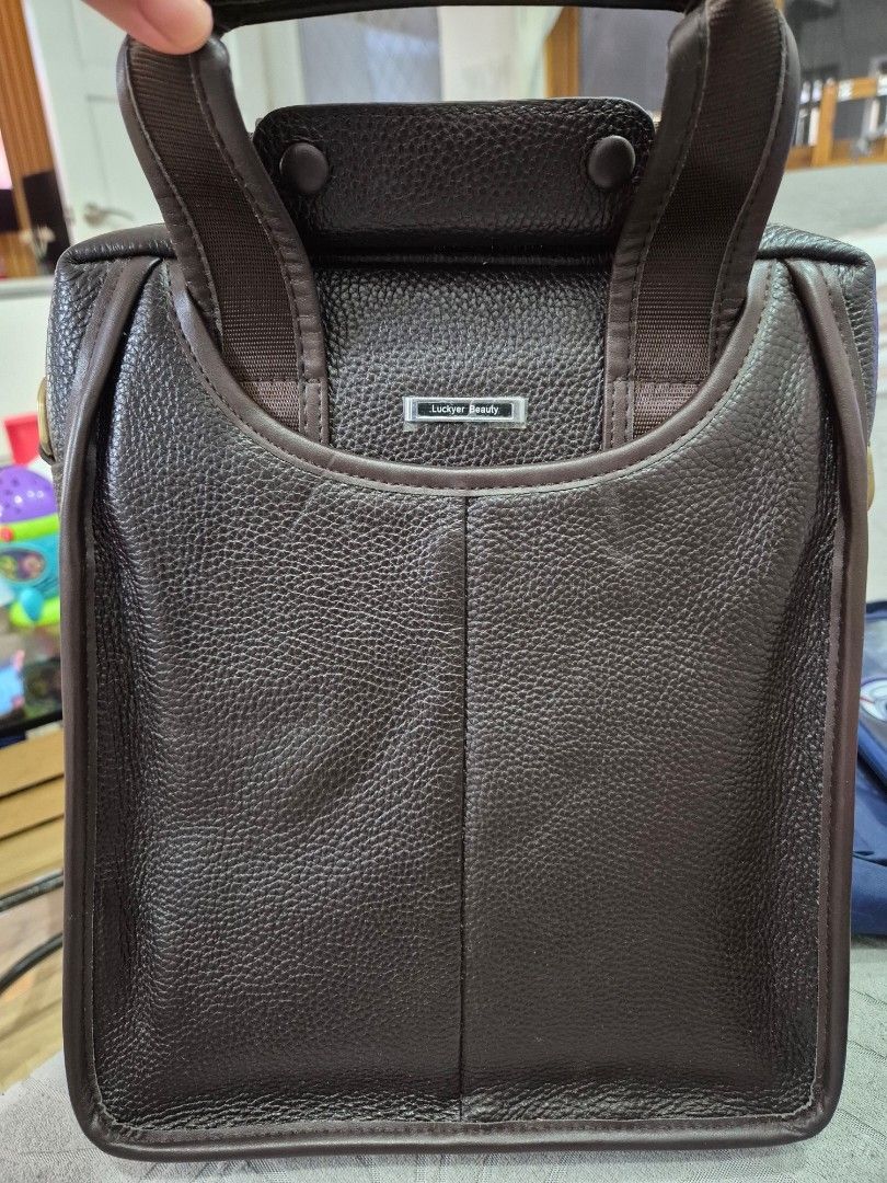 Brown Leather Laptop Bag (Category: Laptop Bags & Sleeves) located in Manila. Submitted by bajoyskie (Listing ID 1422434611, Image 1). Description: - Brown textured leather laptop bag - Top handle and detachable shoulder strap - Zippered main compartment - Interior pocket - Gold-toned hardware - Suitable for laptops and essentials.
