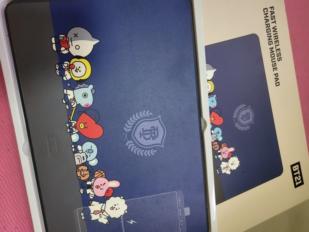 BT21 Fast Wireless Charging Mouse Pad (Category: Mouse & Mousepads) located in Taguig. Submitted by myhotstuff.kr (Listing ID 1423935092, Image 1). Description: - BT21 mouse pad with wireless charging - Navy blue surface - Features BT21 characters and crest design - Includes original box - Ideal for BT21 enthusiasts.