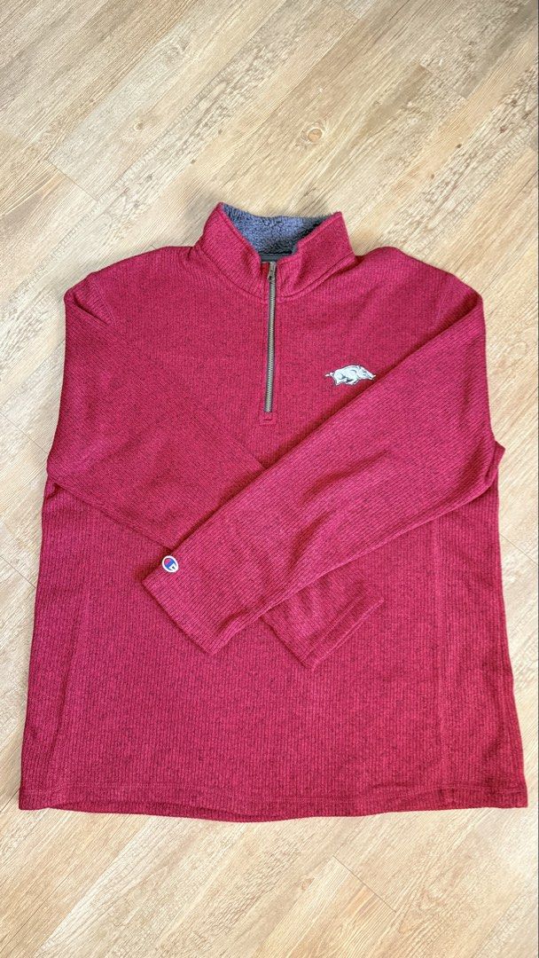 Champion Arkansas Razorbacks Pullover (Category: Coats, Jackets and Outerwear) located in San Pablo. Submitted by chinitokiddd (Listing ID 1423865028, Image 1). Description: - Maroon Champion pullover - Features Arkansas Razorbacks logo - Champion logo on sleeve - Half-zip closure - Soft, gray-lined collar - Ribbed texture - Solid maroon color.