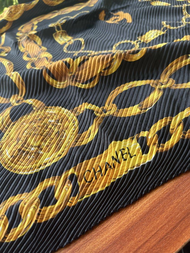 Chanel Pleated Chain Print Scarf (Category: Luxury Accessories) located in Oroquieta. Submitted by mightyfalcon.f3b3e6 (Listing ID 1423912127, Image 3). Description: - Chanel scarf - Black pleated design - Gold chain print - Chanel logo and branding present - Neatly sewn edges - A fashionable accessory.