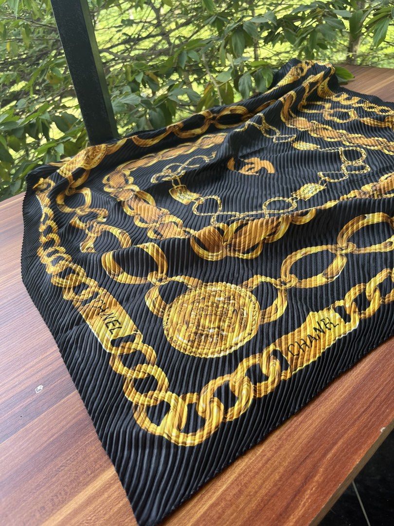 Chanel Pleated Chain Print Scarf (Category: Luxury Accessories) located in Oroquieta. Submitted by mightyfalcon.f3b3e6 (Listing ID 1423912127, Image 2). Description: - Chanel scarf - Black pleated design - Gold chain print - Chanel logo and branding present - Neatly sewn edges - A fashionable accessory.