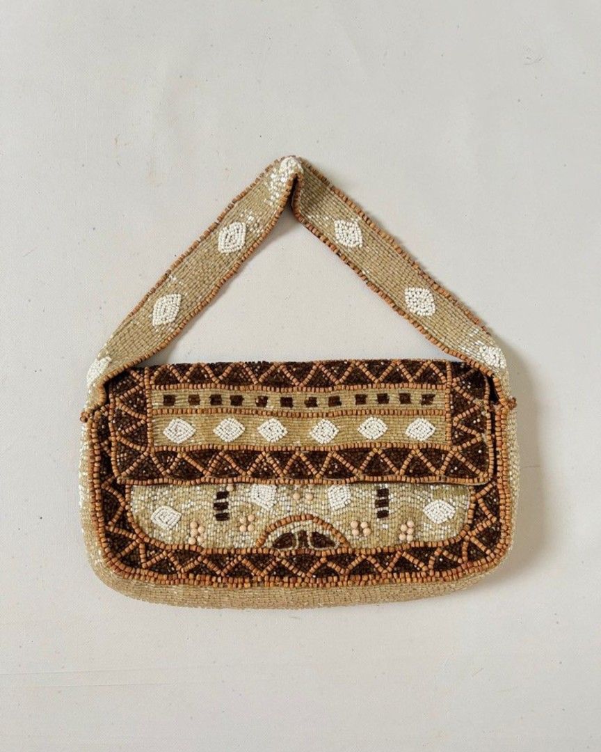 Christiana Beaded vintage Handbag (Category: Shoulder Bags) located in Manila. Submitted by thewalkingmuse (Listing ID 1423883399, Image 1). Description: - Christiana beaded shoulder bag - Detailed pattern in brown, white, and beige beads - Features a top handle - Magnetic closure - Lined with brown fabric bought this from another seller here for 4k pesos and never really got the chance to use it.selling it for such a cheap price already flaws: s