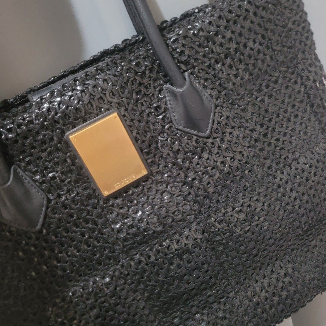 Couronne Black Bag (Category: Luxury Bags & Wallets) located in Pasig City. Submitted by bunny.bella (Listing ID 1423842239, Image 2). Description: - Couronne black handbag - Unique mesh-like design - Gold rectangular detail on front - Two handles - Brand tag inside Excellent used condition Minimal flaw on one side.