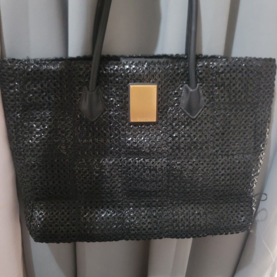Couronne Black Bag (Category: Luxury Bags & Wallets) located in Pasig City. Submitted by bunny.bella (Listing ID 1423842239, Image 1). Description: - Couronne black handbag - Unique mesh-like design - Gold rectangular detail on front - Two handles - Brand tag inside Excellent used condition Minimal flaw on one side.