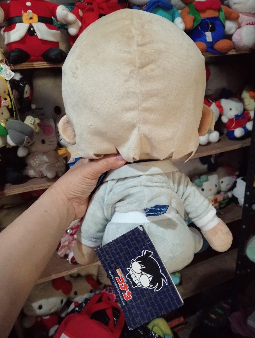 Detective Conan Preciality Plush Toy (Category: Plushies & Soft Toys) located in Bulacan. Submitted by renasophiatoystore2020 (Listing ID 1423790270, Image 2). Description: - Detective Conan plush toy - Features light-colored hair - Includes a blue scarf - Wearing a light gray outfit - Comes with a tag - Made in Vietnam.