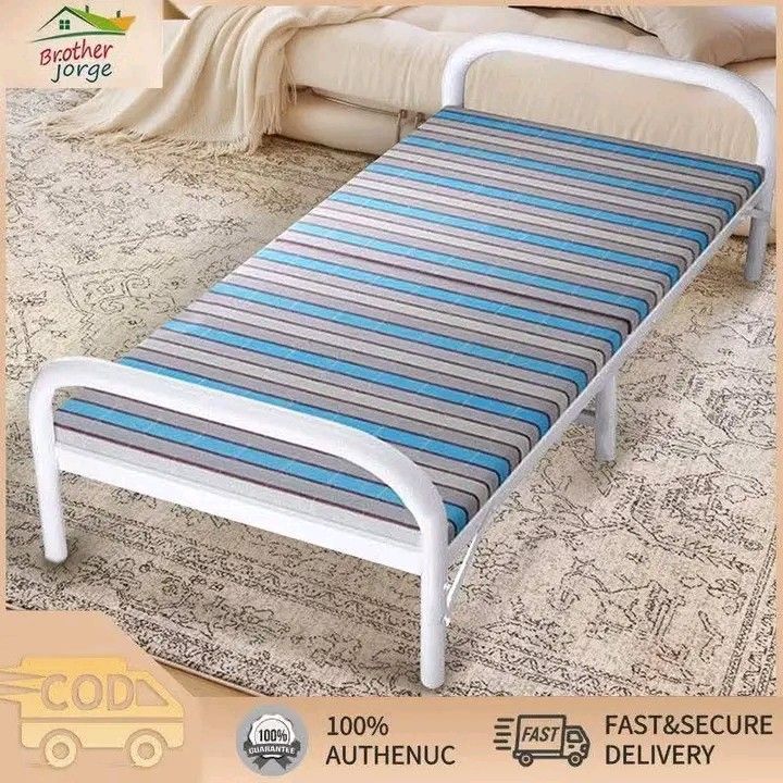 Foldable Single Bed with Mattress (Category: Bed Frames & Mattresses) located in Manila. Submitted by micoooy (Listing ID 1423830141, Image 2). Description: Foldable single bed is perfect for small spaces. It features a striped mattress and a sturdy white metal frame. The bed is easy to set up and fold away for storage. Dimensions are approximately 180cm long, 75cm wide, and 40cm high. It's a convenient and portable sleeping solution..