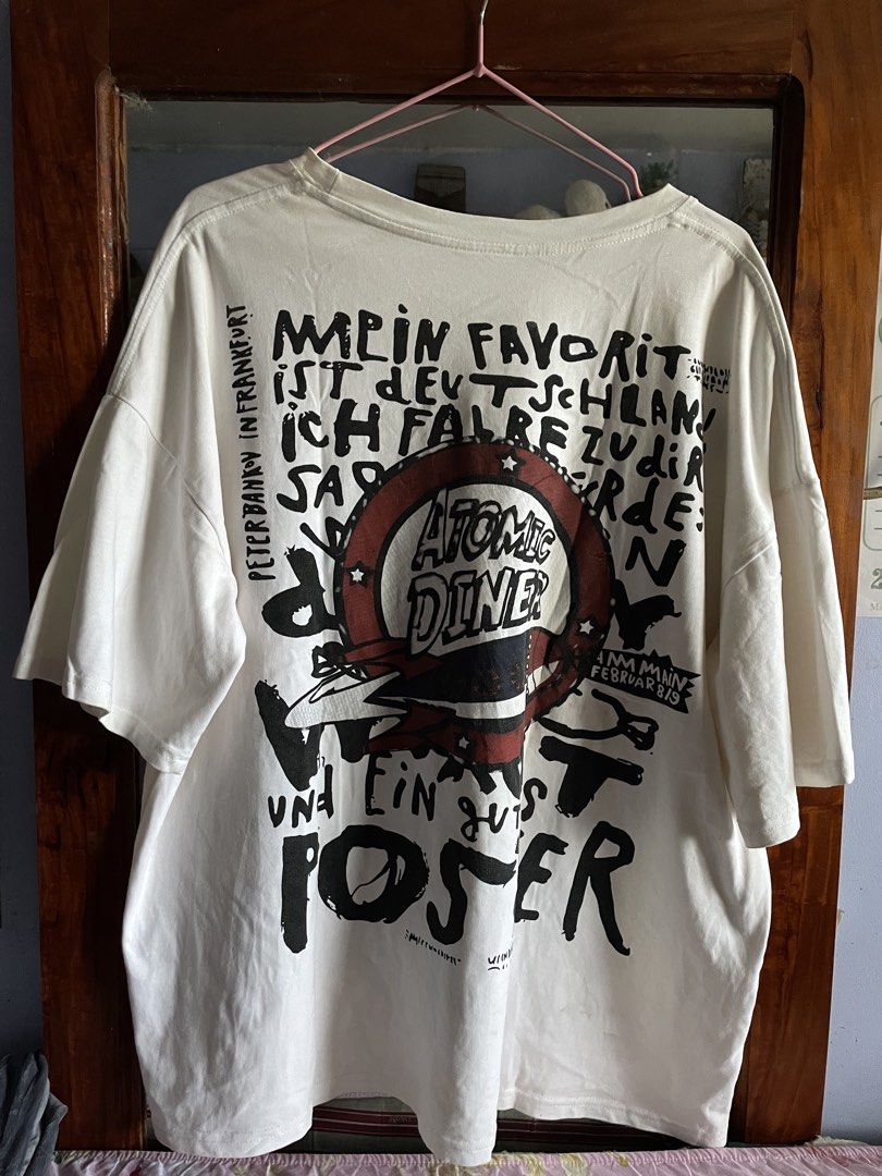 Graphic Tee (Category: Tshirts & Polo Shirts ) located in Camalig. Submitted by vvsperr (Listing ID 1423816029, Image 1). Description: size: XL (25” W 27” L) loc: albay mop: gcash condition: goods ang print, with stains.