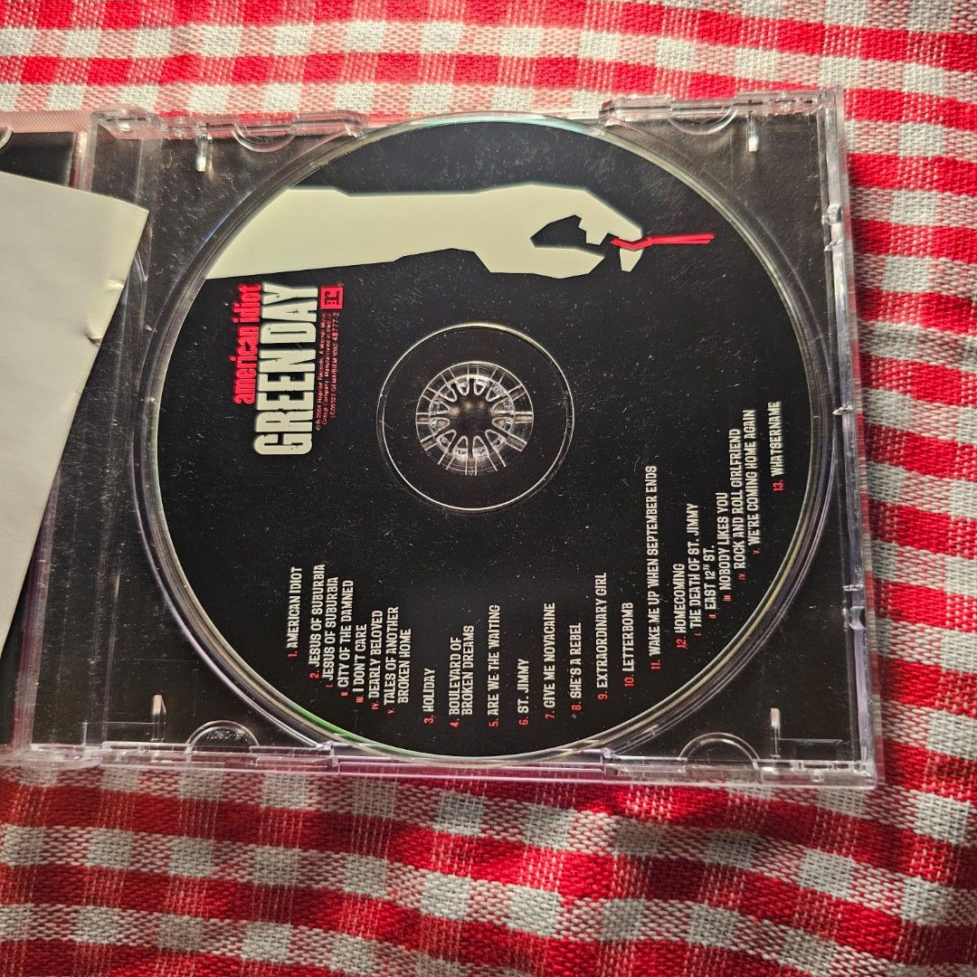 Green Day American Idiot CD - CD Mint (Category: CDs & DVDs) located in Quezon City. Submitted by serefrenpaz (Listing ID 1423858951, Image 2). Description: Original CD of Green Day's iconic album, American Idiot. Includes the CD, the original case, and the booklet with lyrics and additional artwork. Features tracks like "American Idiot," "Holiday," and "Wake Me Up When September Ends." A must-have for any Green Day fan..