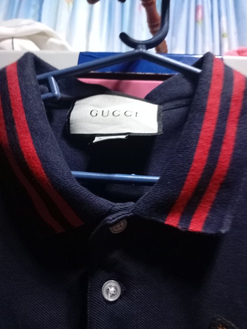 Gucci Cat Embroidered Polo Shirt (Category: Tshirts & Polo Shirts ) located in Adams. Submitted by odddragon-f00047 (Listing ID 1423969669, Image 3). Description: - Gucci navy blue polo shirt - Embroidered cat design on chest - Red and navy striped collar - Button-down placket 20x27 - Short sleeves - Made in Italy.