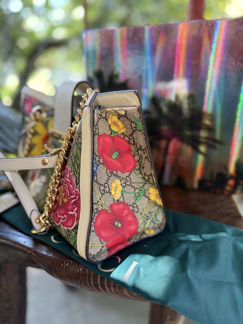 Gucci Floral Print Chain Bag (Category: Luxury Bags & Wallets) located in Manila. Submitted by fivethousandlilies (Listing ID 1423969002, Image 2). Description: - Authentic Gucci handbag with floral print - Includes original box, dust bag, and shopping bag - Features a chain strap and secure lock closure - Interior with multiple compartments for organization - Serial number visible inside - Minor wear on the strap.