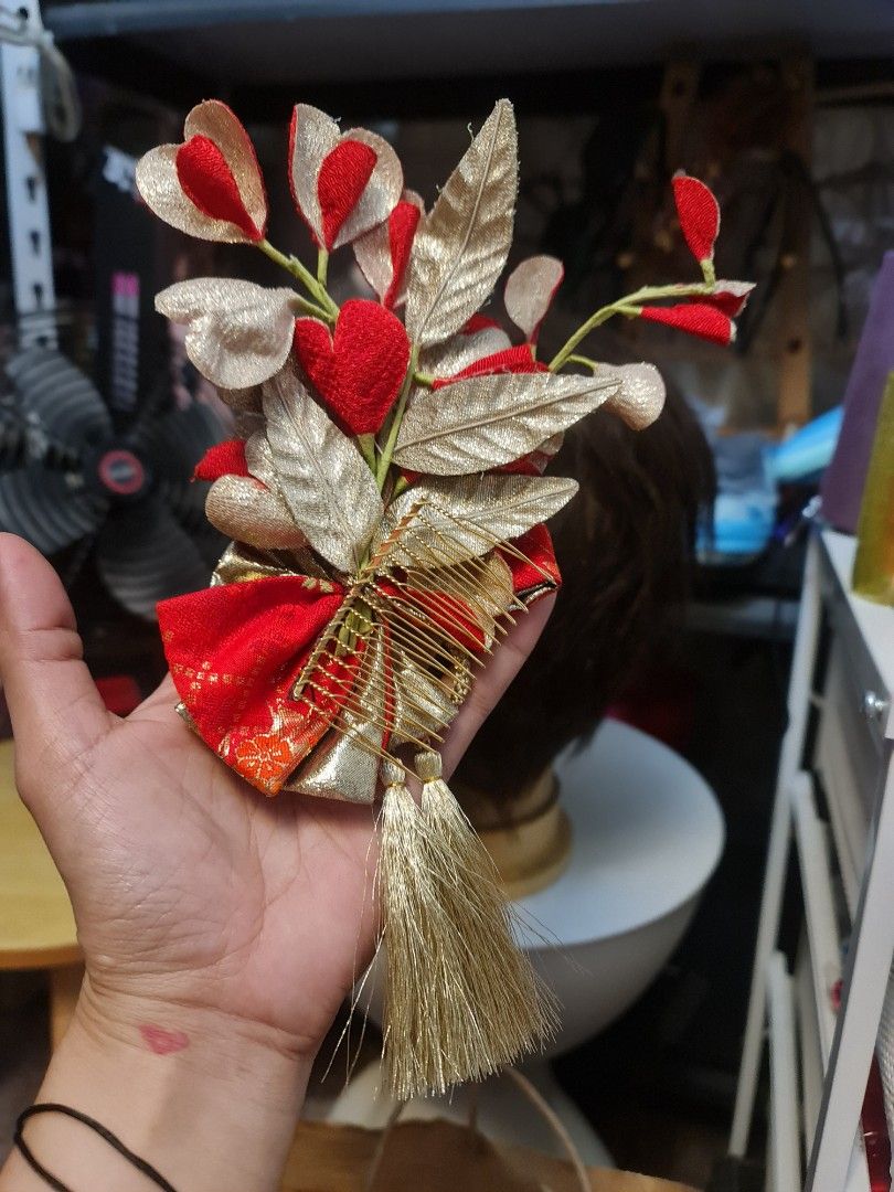 Japanese Hair Ornament (Category: Hair Accessories) located in Angeles City. Submitted by reallygraceful (Listing ID 1423911657, Image 3). Description: - Japanese hair ornament - Features red fabric flowers and gold accents - Includes a gold bow and tassel - Attaches to hair with a comb - Perfect for special occasions - Good Condition NO LOW BALLING ‼️ .