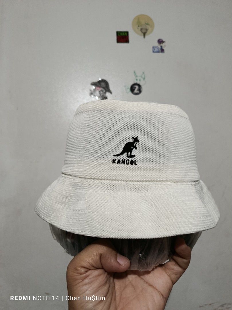 Kangol Bucket Hat (Category: Caps & Hats) located in Calamba. Submitted by chanmagpantay (Listing ID 1423962550, Image 1). Description: - Authentic Kangol bucket hat - Color: White - Features the iconic Kangol logo - Made of textured fabric - Classic bucket hat shape - Interior tag confirms brand.