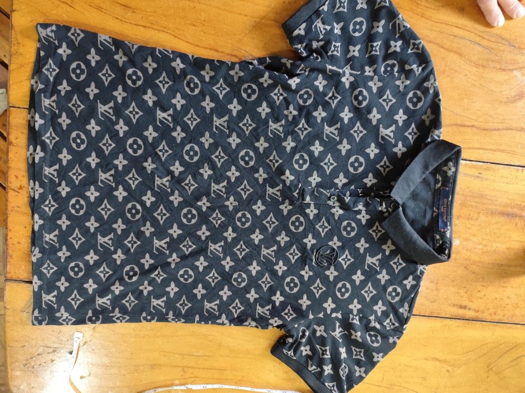 Louis Vuitton Monogram Polo Shirt (Category: Luxury Apparel) located in Davao. Submitted by violentino74125 (Listing ID 1423917252, Image 1). Description: - Authentic Louis Vuitton polo shirt - Features the iconic monogram pattern - Classic polo collar and short sleeves - Black color with brown monogram - Button-up placket - Small Louis Vuitton logo on chest.