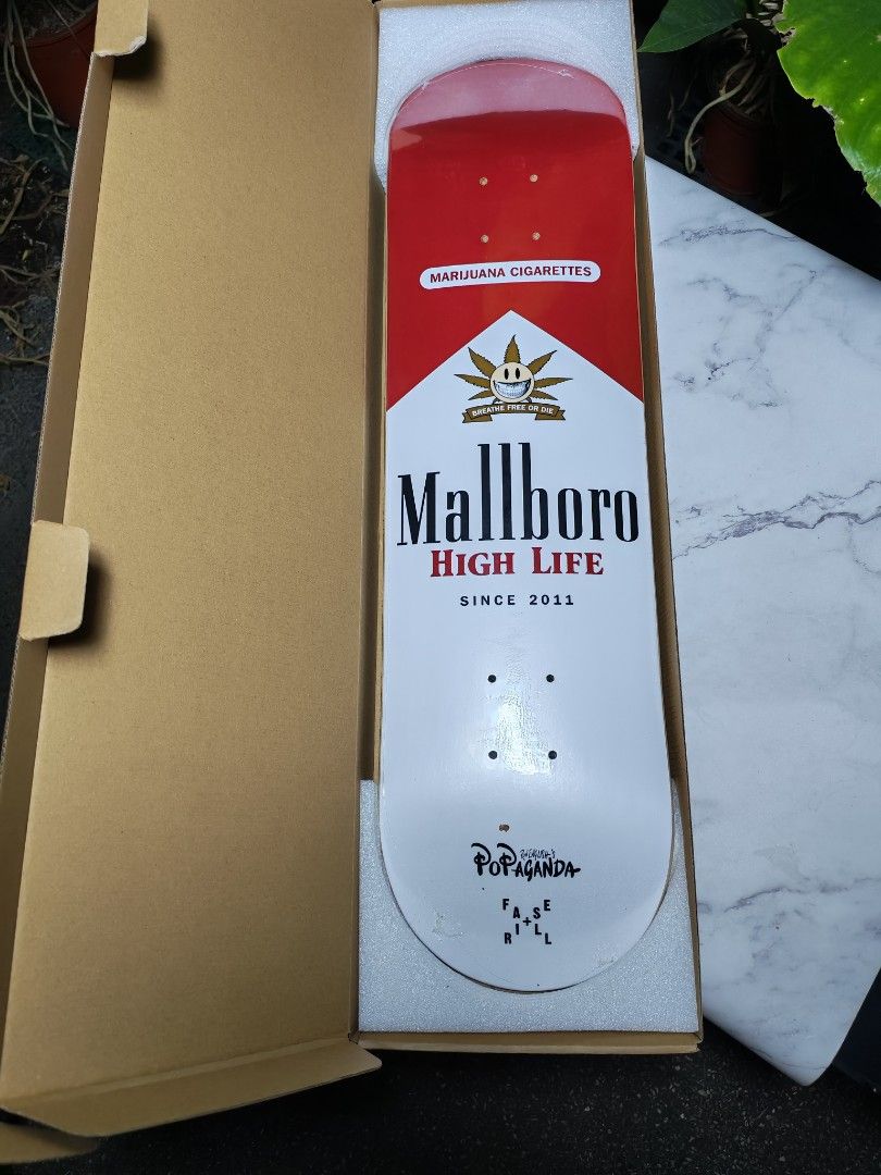 Mallboro High Life Skateboard (Category: Skates, Rollerblades & Scooters) located in Quezon City. Submitted by danilo.danilo4 (Listing ID 1423904485, Image 2). Description: - Unique skateboard design with 'Mallboro High Life' graphic. - Deck color scheme: Red and white. - Features 'Mallboro' logo and 'Marijuana Cigarettes' text. - 'Popaganda' text on the bottom of the deck. - Comes in original packaging..