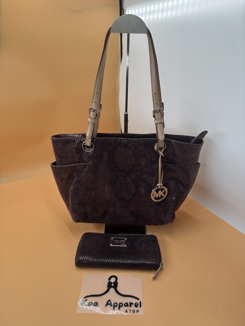 Michael Kors Snakeskin Handbag and Wallet Set (Category: Luxury Bags & Wallets) located in Cagayan de Oro. Submitted by KoaApparelAtbp. (Listing ID 1423797813, Image 2). Description: - Michael Kors handbag and wallet set - Color: Purple - Handbag: - Snakeskin pattern - Zip closure - Two side pockets - Multiple interior compartments - "Made in China" tag - Wallet: - Zip closure - Metal logo Wallet has sign of use.