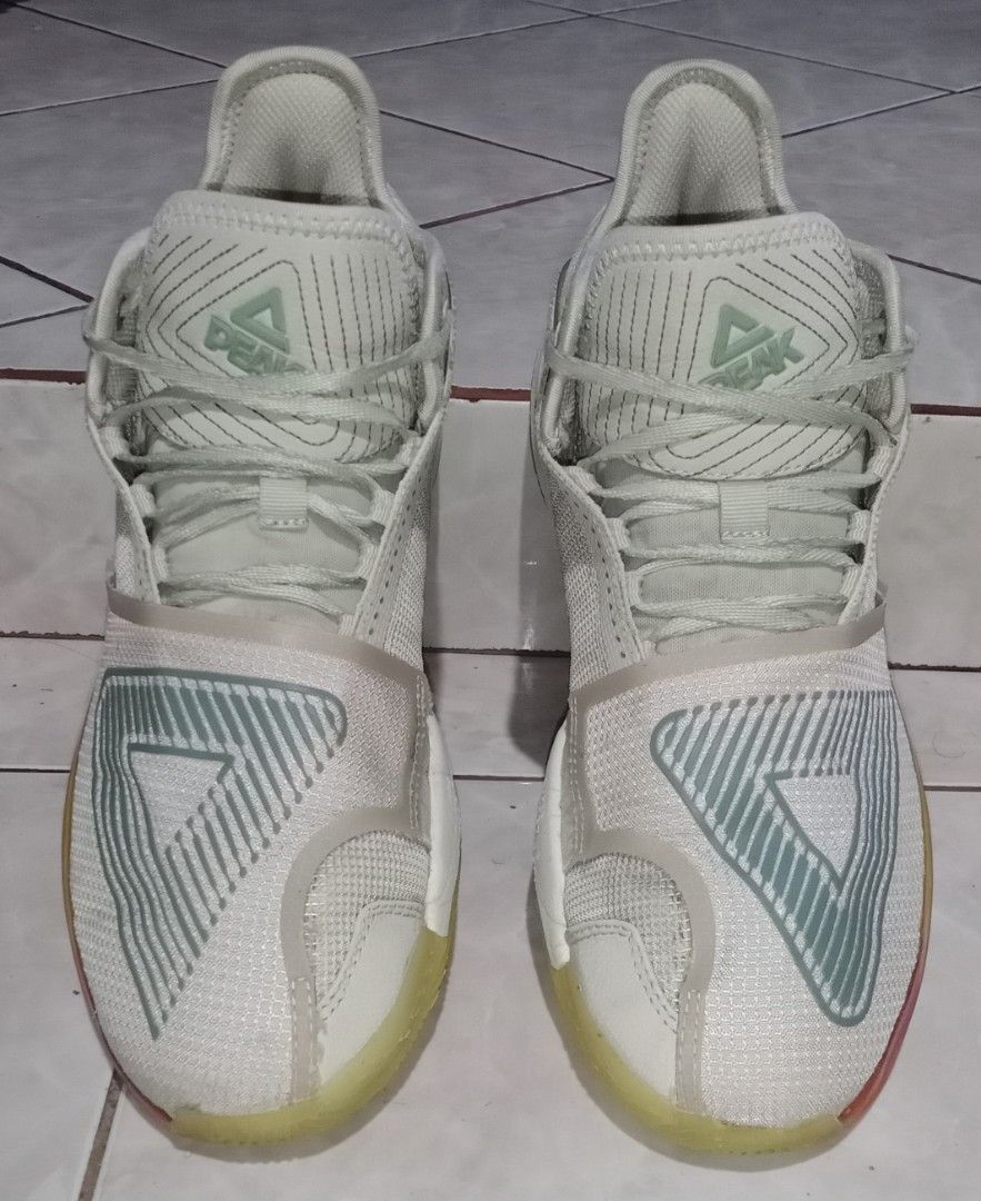 Peak Taichi Basketball Shoes (Category: Sneakers) located in Baguio. Submitted by jmlthrift27209 (Listing ID 1423888498, Image 2). Description: - Peak Taichi basketball shoes - Color: Light green and white - Unique design with Peak logo - Yellow soles with translucent appearance - Lace-up closure - Padded collar for comfort - Size tag visible in photos.