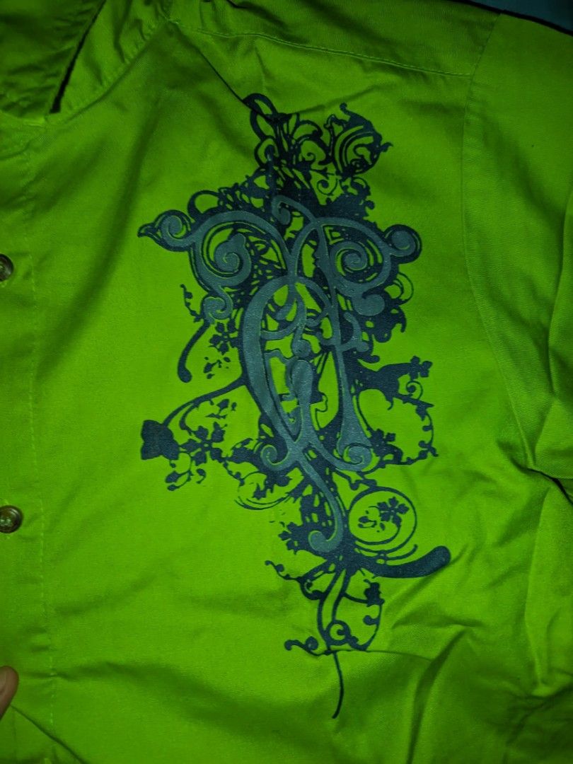 Polo by Bro. John Green Shirt (Category: Tshirts & Polo Shirts ) located in Tarlac. Submitted by yellowieewo (Listing ID 1423947582, Image 2). Description: - Polo by Bro. John shirt - Green, short-sleeved - Dark grey design on front - Button-down style - Collared neckline - Brand label visible - Classic and stylish.