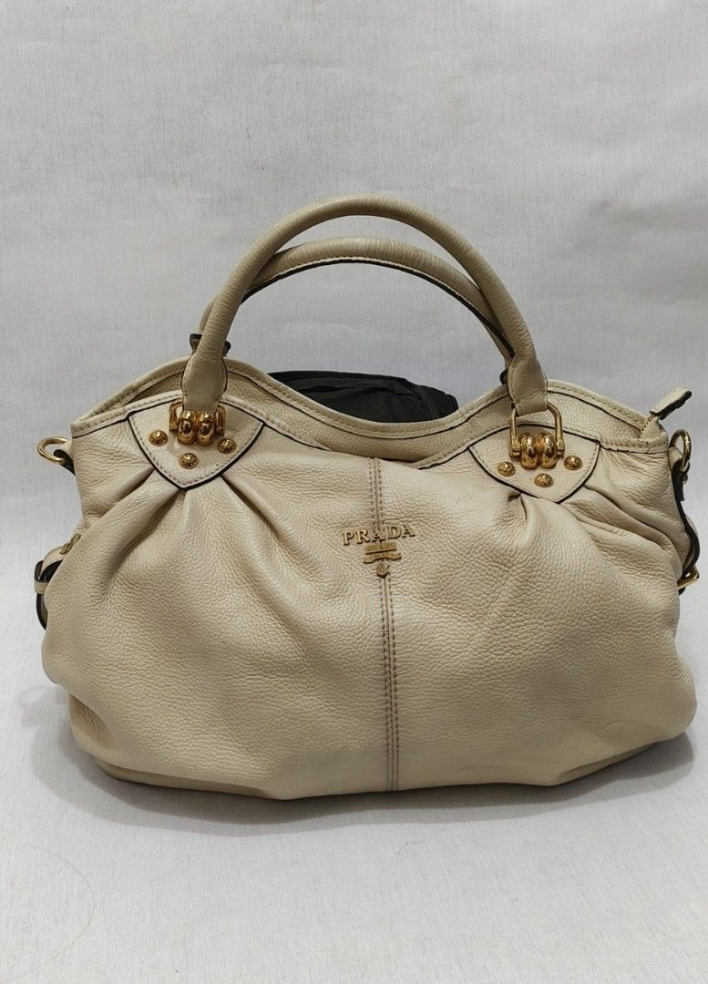 Prada Pebbled Leather Tote Bag (Category: Luxury Bags & Wallets) located in Baguio. Submitted by PreiLoveMaria (Listing ID 1423909663, Image 2). Description: PRADA Tote Bag Elegant beige genuine leather tote classy, spacious, and perfect for everyday luxe styling. • Very good used condition • Normal signs of wear (please manage expectations) • No tag found inside (not sure if cut tag) • With sling slot but no sling included • Color: Beige • Dimen