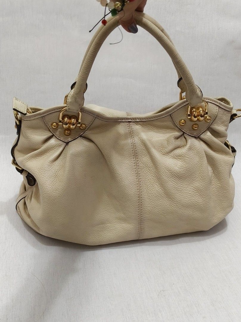 Prada Pebbled Leather Tote Bag (Category: Luxury Bags & Wallets) located in Baguio. Submitted by PreiLoveMaria (Listing ID 1423909663, Image 3). Description: PRADA Tote Bag Elegant beige genuine leather tote classy, spacious, and perfect for everyday luxe styling. • Very good used condition • Normal signs of wear (please manage expectations) • No tag found inside (not sure if cut tag) • With sling slot but no sling included • Color: Beige • Dimen