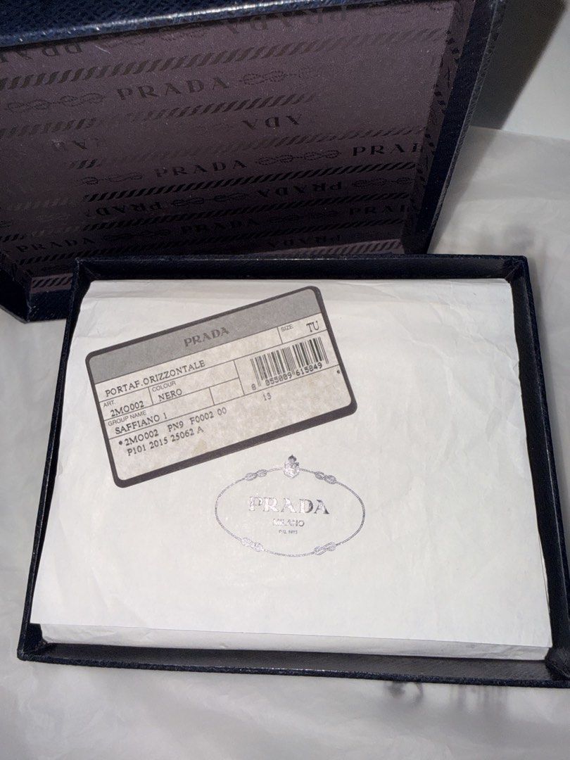 Prada Saffiano Leather Wallet (Category: Luxury Bags & Wallets) located in Manila. Submitted by timokschickenpalabok (Listing ID 1423858457, Image 2). Description: - Authentic Prada wallet - Black Saffiano leather - Includes original box and packaging - Multiple card slots - Bill compartments - Prada logo visible - Classic design.